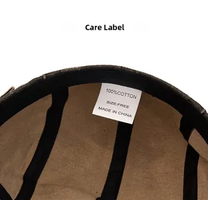 Detail view of cotton newsboy cap interior showing fabric lining and wash care label