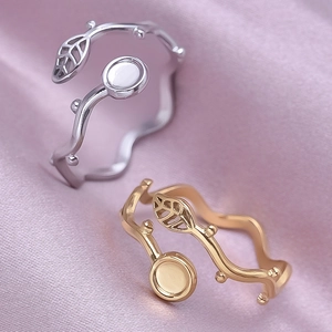 304 stainless steel leaf rings in gold and silver finish on soft pink silk background