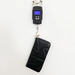 Black PU leather long zip wallet featuring geometric embossed stitching and gold hardware