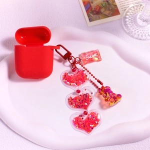 Cute red silicone AirPods case with pink glitter bear and sweet candy charm keychain