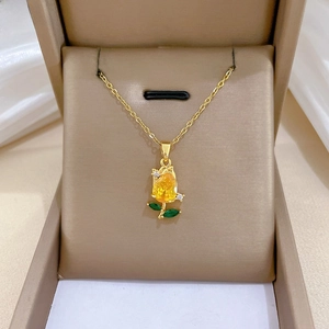 Detail of tulip necklace with yellow pear-shaped stone and green leaf gems