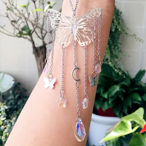Detail of butterfly suncatcher with crystal prisms and silver metal moon and star charms