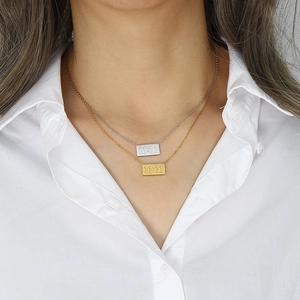 Minimalist 18K gold and silver layered necklace featuring 11:11 angel number pendants