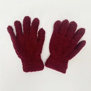 Macro detail of wine red chenille winter gloves with thick knit texture and elastic cuffs