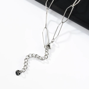 Detail of silver stainless steel necklace showing lobster clasp and adjustable extension chain