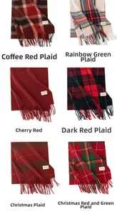 Detail view of various classic plaid and solid cashmere-feel winter scarves with tassels