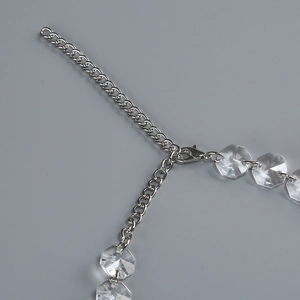 Close-up of silver extension chain with lobster clasp and clear octagonal crystal bead