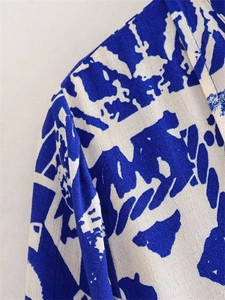 Detailed view of abstract blue and white ink print fabric with high-quality stitching