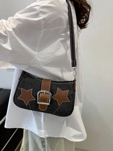 Vintage dark denim shoulder bag with brown leather star patches and metallic buckle detail