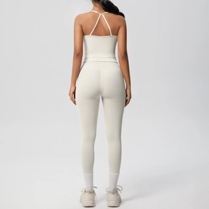 Detail of cross-back yoga tank top and high-waisted leggings in creamy white