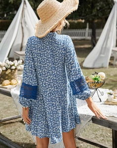 Outdoor shot of floral dress with long sleeves and navy blue lace patchwork details