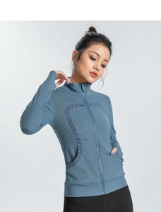 Detail of grey-blue yoga jacket featuring thumbholes and curved seam stitching