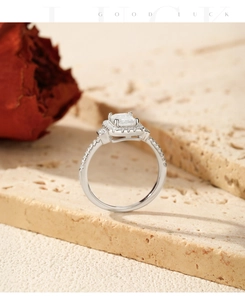Macro side view of emerald cut moissanite ring with halo and pavé band decoration