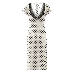 Detail view of back V-neck with black lace trim and tie-up closure on polka dot dress