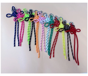 Close-up of assorted colorful hand-woven nylon knots with reflective stitching and rings