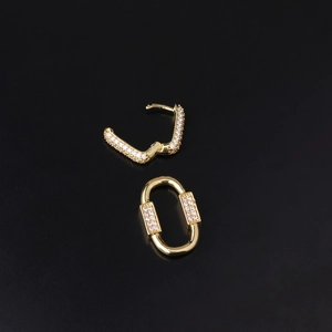 Bohemian gold-plated earrings with colorful zircon crystals on black background