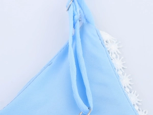 Detail of light blue chiffon dress with white lace trim and metal strap rings
