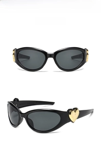 Detail view of black heart-shaped sunglasses with golden metal accents and product specs