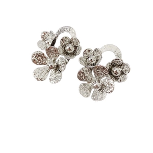 Elegant silver-tone floral stud earrings with hammered metal texture and layered petals
