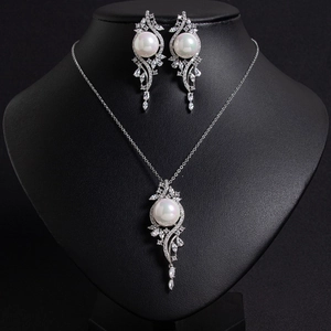 Detail showing elegant teardrop zircon and pearl necklace jewelry set on black bust
