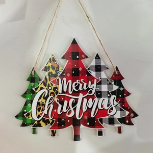 Detail of wooden Merry Christmas sign with plaid and leopard print trees for door hanging