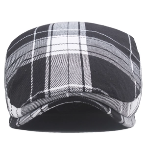 Detailed view of the classic black and white plaid newsboy cap with high-quality fabric texture
