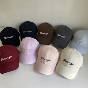Flat lay display of 9 colors of cotton baseball caps with Hiranga letter embroidery