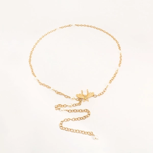 Close-up of golden metal waist chain with elegant bee pendant and delicate pearls