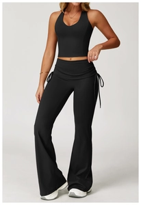 Detail of black yoga set with high waist flare pants and drawstring fold-over waistband