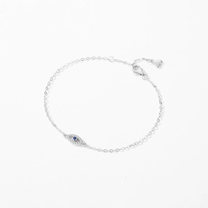 S925 sterling silver evil eye bracelet with blue crystals and heart charm on white background