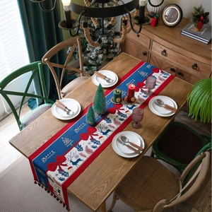 Merry Christmas jacquard table runner with red and blue reindeer patterns and tassels