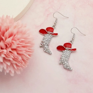 Detail of western boots earrings with red cowboy hat and sparkling zircon rhinestones