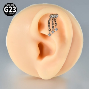 Macro view of solid G23 titanium helix earring featuring three chains and zircon stones