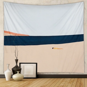 Detail of bohemian tapestry featuring abstract beach scene and minimalist art figures