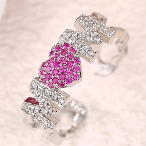 Macro shot of silver MOM ring with pavé heart and pink zircons on textured surface