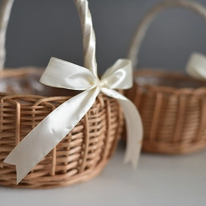 Handmade woven bamboo flower basket with cream ribbon bow for weddings and home decor