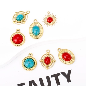 Detail of vintage 18K gold plated charms with turquoise and red stones for jewelry making