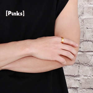 Close-up of a 18k gold plated titanium steel ring worn on a finger with a black background