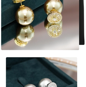 Macro detail of French retro double-headed pearl earrings with zircon inlays and gold plating