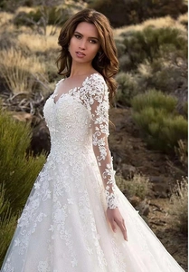 Exquisite white lace embroidery detail on long sleeves of this bridal wedding gown