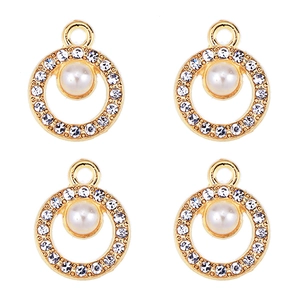 Macro detail of four gold pendants featuring a central pearl surrounded by zircon stones