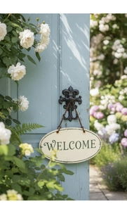 Vintage welcome plaque with iron fleur-de-lis hook on blue door with roses