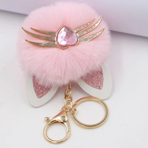 Pink plush cat paw keychain with leopard ears, golden whiskers and heart rhinestone detail