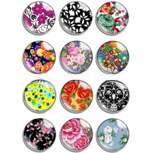 Detail view of 12 mixed floral patterns on round luminous glass cabochon gems
