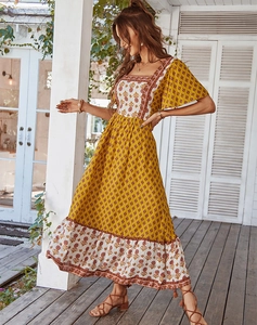 Detail view of square neck floral print dress with short flare sleeves and airy fabric