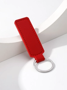 Detail of red PU leather keychain featuring neat stitching and a silver metal ring
