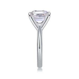 Detailed side view of emerald cut gemstone ring with a classic four-prong silver setting
