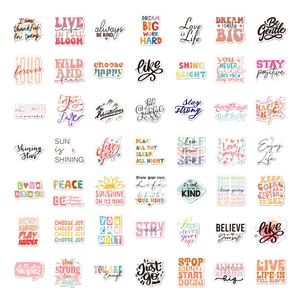 Flat lay of 49 positive holographic motivational stickers with white border on white background