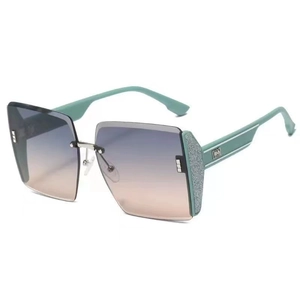 Detail view of mint green rimless sunglasses with gradient lenses and silver temple accents
