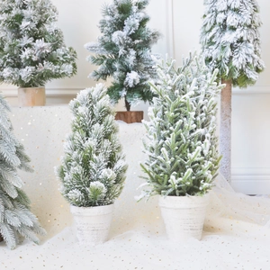 Miniature flocked Christmas trees on white cedar bases for elegant winter table decor
